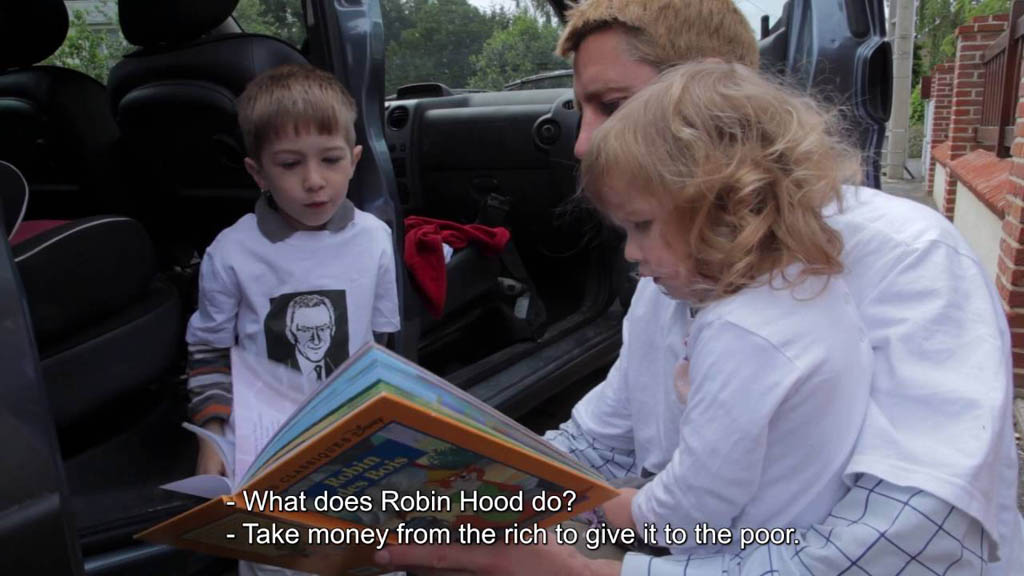 In this screen grab from the French documentary Merci Patron!, director Franois Ruffin reads a Robin Hood story to his children. Merci Patron is being shown at the Festival du nouveau cinma in Montreal.